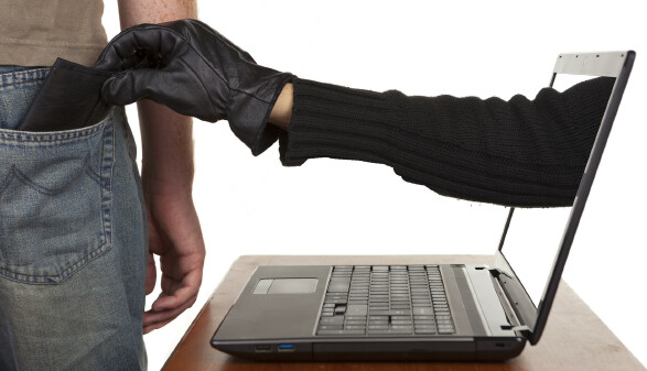 R&auml;uberhand greift aus dem Computerbildschirm in die Hosentasche und nimmt die Geldb&ouml;rse