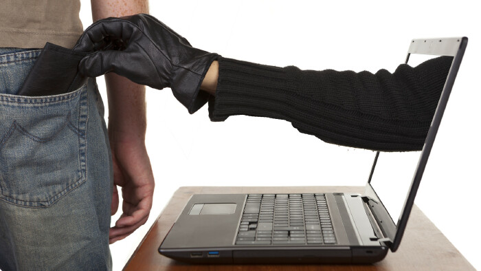 R&auml;uberhand greift aus dem Computerbildschirm in die Hosentasche und nimmt die Geldb&ouml;rse